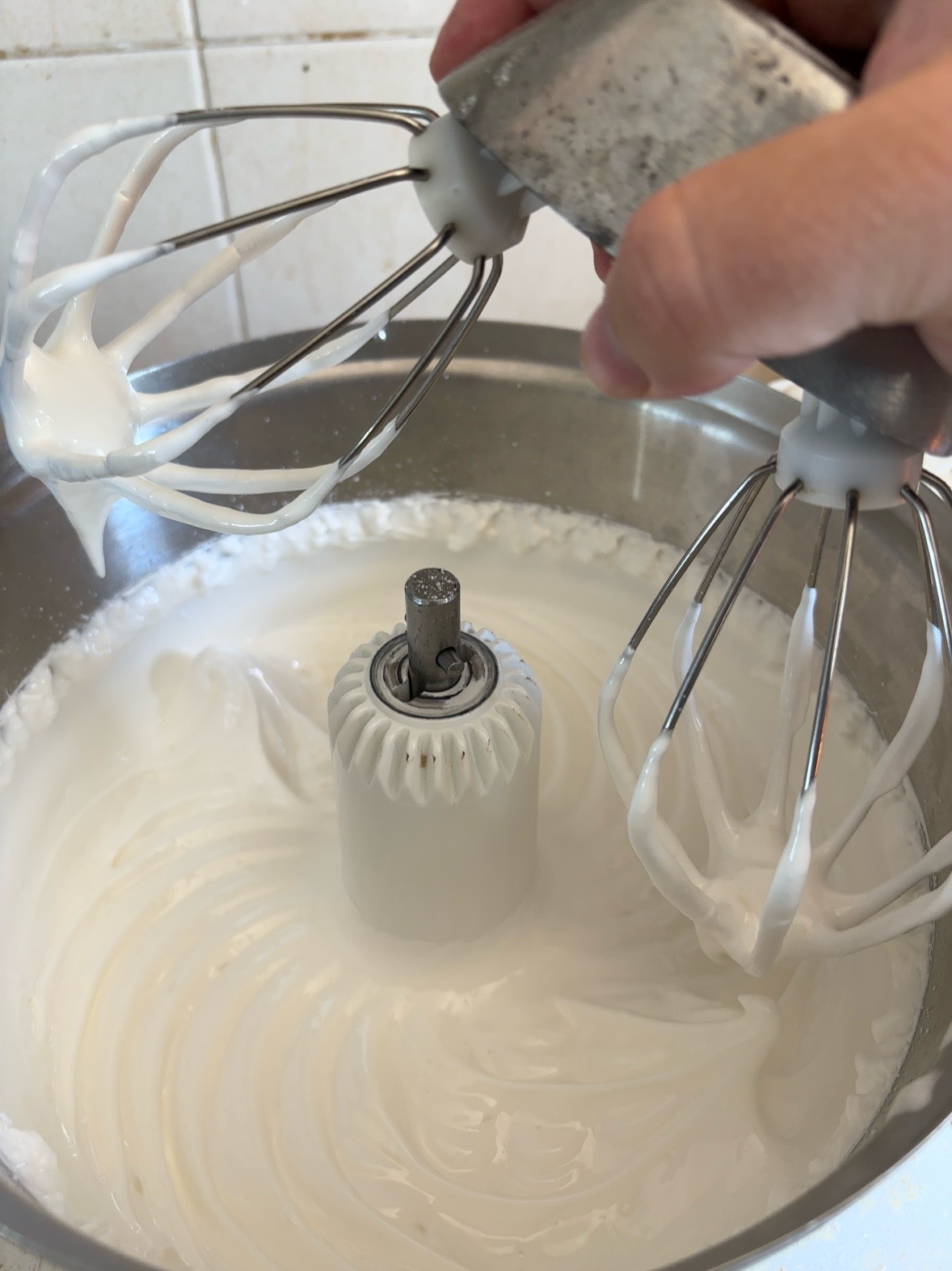Whipping the egg whites into a stiff meringue