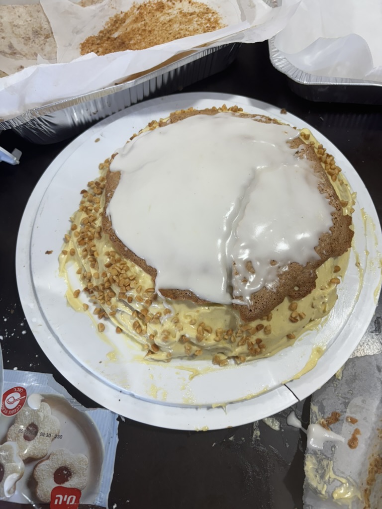 Pouring the white lemon fondant over the top layer