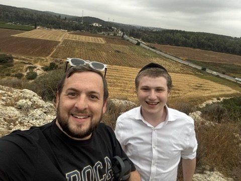 Father-and-son selfie with the Elah Valley fields behind